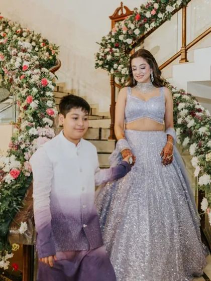 The bride looks like a princess descending the stairs, her wavy hair flowing.