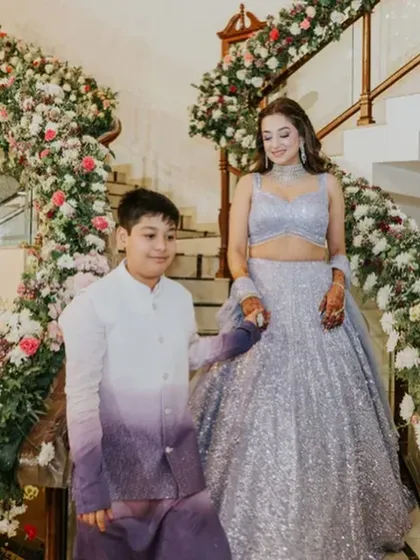 The bride looks like a princess descending the stairs, her wavy hair flowing.
