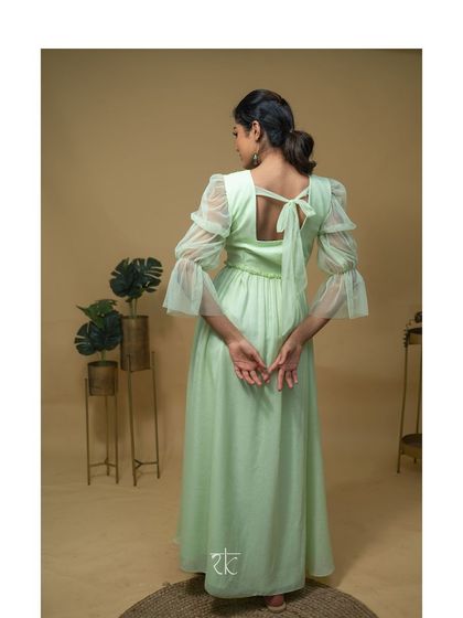 The back of the dress features a simple tie-up bow, adding a charming and feminine detail.