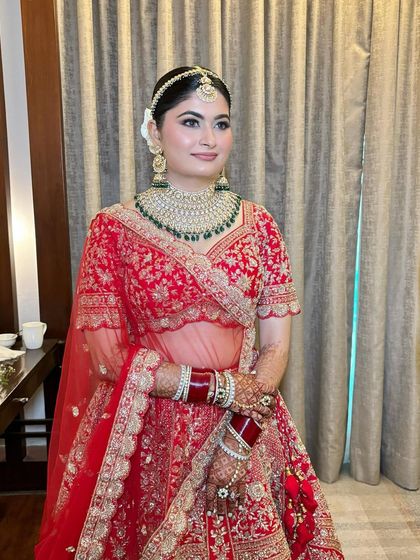 The complete traditional bridal look for Sonal, looking absolutely radiant in her red lehenga.