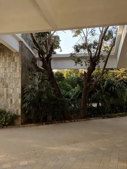 Here, a covered walkway at Vidyamandir School opens up to a view of the lush, landscaped grounds. We intentionally designed these transitional spaces to blur the boundary between inside and outside, ensuring students and faculty are always connected to the natural environment.