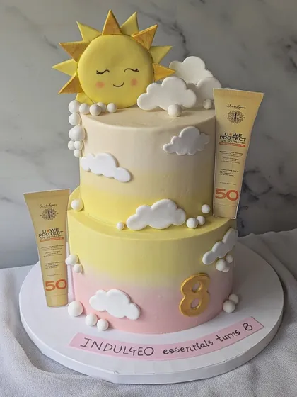I created this two-tier cake to celebrate the 8th anniversary of Indulgeo Essentials and the launch of their new sunscreen. It features a soft, sky-like buttercream finish and fully edible replicas of the product, turning a brand milestone into a delicious work of art.