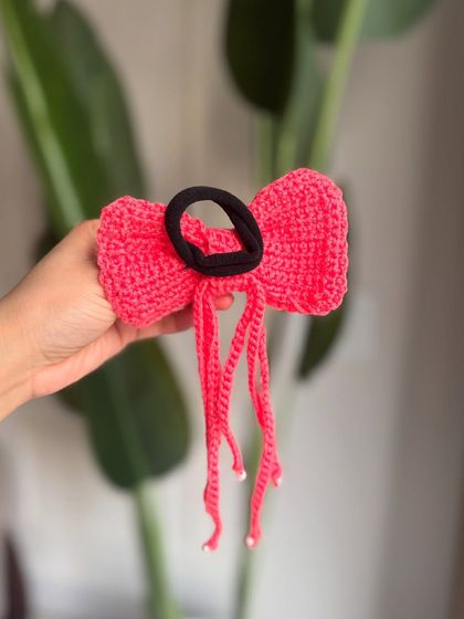 The back view of our tassel bow, showing the sturdy hair tie that keeps it securely in place.