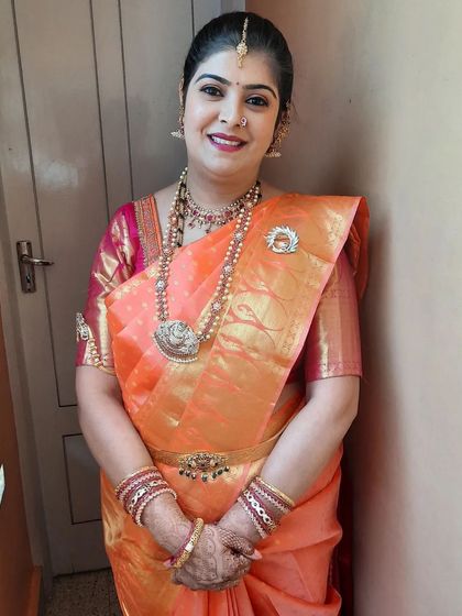 A full-length shot of the client in her beautiful peach saree.