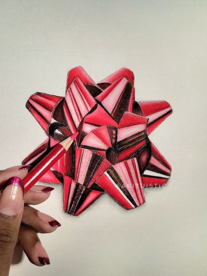 Me holding a red pencil to the finished bow drawing, showing how I create these realistic textures.