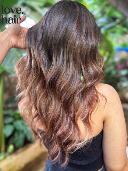 A side view of our 'blush' balayage, showing the subtle rose gold tones woven through the brunette base.