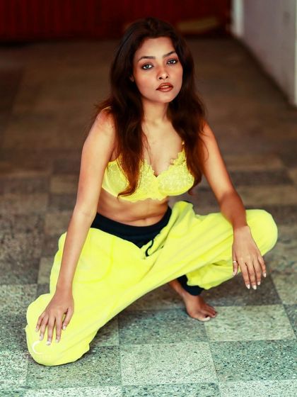 A bold and vibrant portrait that celebrates confidence and color. The yellow lace and matching pants create a fun and fearless look.