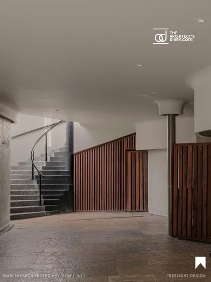 An interior shot from The Architect's Diary feature, showcasing the curved staircase and wooden slat details within the Aqua Pool & Spa.