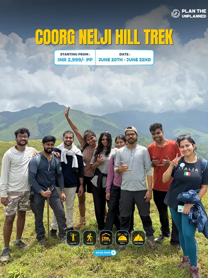 A group of friends on the Coorg Nelji Hill trek, with beautiful mountains in the background.
