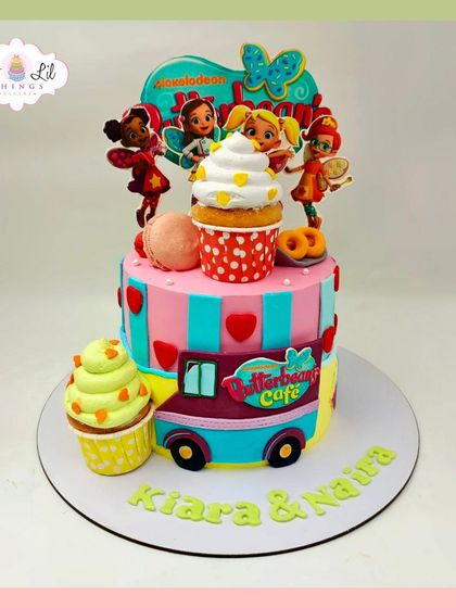 A sweet and colorful cake themed around the show Butterbean's Café, perfect for Kiara and Naira's celebration.