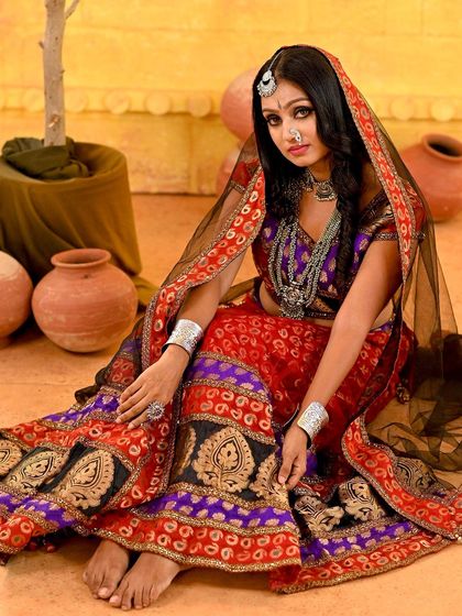 A seated pose from the Rajasthani set, with the model's gaze directed away from the camera. This creates a candid, story-like feel, as if capturing a private moment.