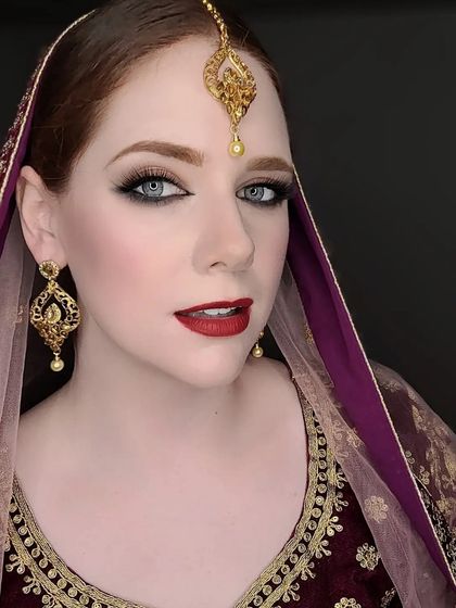 A model looking stunning in our gold-plated earring and maang tika set.