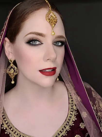 A model looking stunning in our gold-plated earring and maang tika set.
