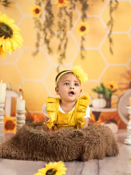 A moment of wonder captured in our sunflower-themed setup. This tummy-time shot is perfect for younger babies, highlighting their strength and curiosity.