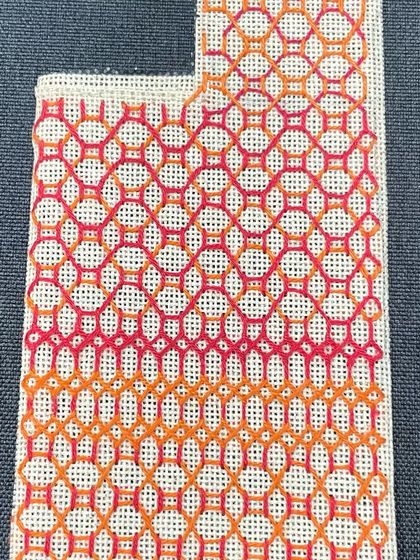 A phone insert with a geometric pattern in warm orange and pink tones. This is another example of how we can customize designs to your taste.