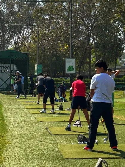 A full line of golfers at our Fitting Studio end of the range, all working towards a better game.