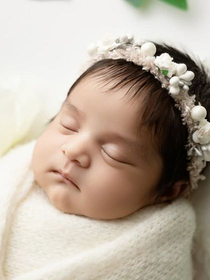 A detailed close-up of the baby's face from our simple greenery-themed shoot.