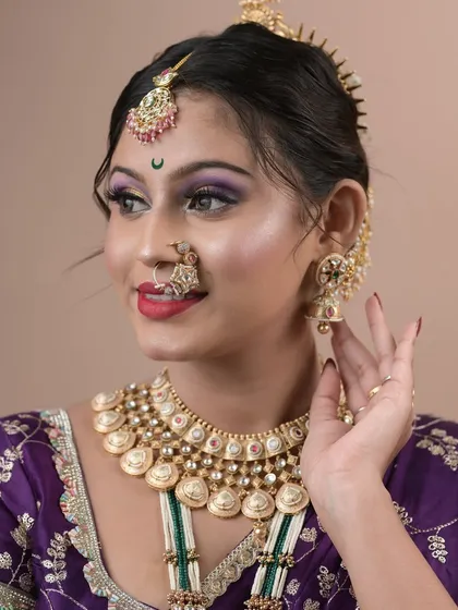 A student's exam day work, showing a colorful and creative Maharashtrian bridal look with purple and yellow eyeshadow.