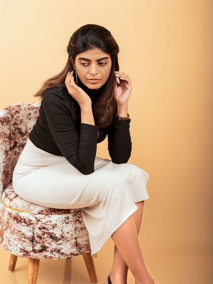 A thoughtful and composed studio portrait. The simple styling and focused expression make this a strong and professional headshot.