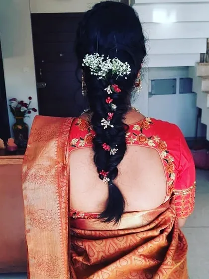 A full view of the fishtail braid, showing how it pairs with an embroidered blouse. This style is both elegant and comfortable, keeping hair neatly off the back.