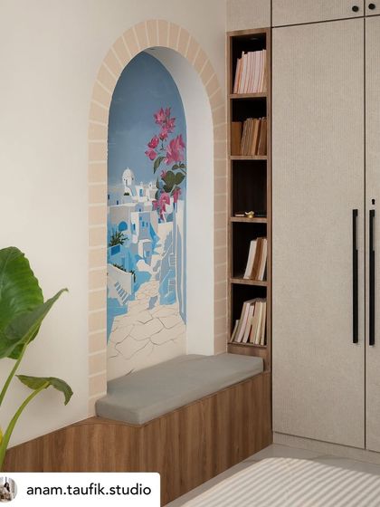 A hand-painted mural in a bedroom nook creates a window to Santorini. The iconic blue and white architecture, framed by a painted brick arch and blooming bougainvillea, offers a permanent escape to a Greek paradise.