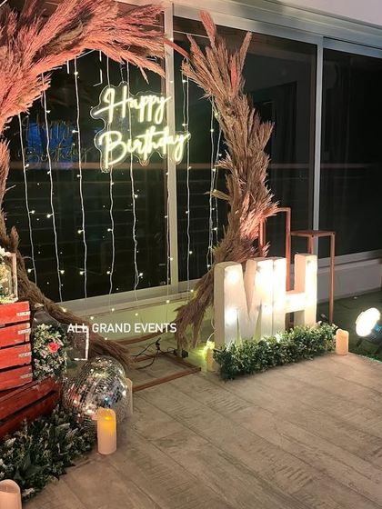 This view highlights the props used, such as rustic red wooden crates, lanterns, and candles, which add to the cozy, rustic charm.