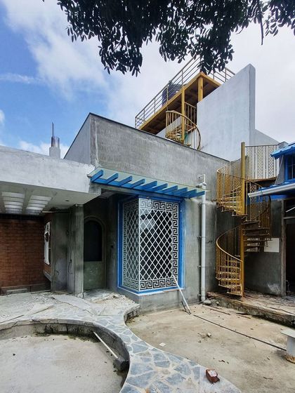 The 'AGA' site, where we are transforming a terrace into a garden space. The yellow spiral staircase adds a pop of color.