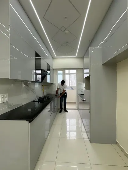 A wide shot of the completed grey kitchen, showing how the design integrates seamlessly with the rest of the open-plan living area.