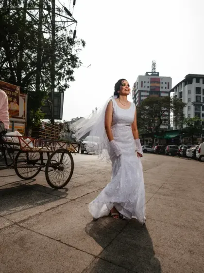 A bride takes a confident stroll through the streets of Mumbai. This shot captures the contrast between the elegant wedding dress and the everyday city life.