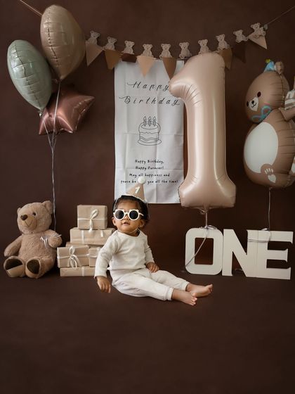 A stylish pose from the birthday boy, leaning back with his sunglasses on. A fun twist on the classic teddy bear theme.