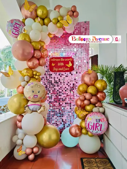 We use eye-catching backdrops like this pink shimmer wall to make your celebration pop. Combined with a balloon garland in rose gold, white, and gold, and fun foil balloons, this setup is perfect for a baby shower or welcoming a baby girl.