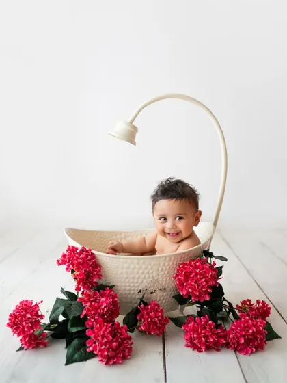 This little one is loving his floral bath session. The pop of red flowers against the clean white background is just stunning.