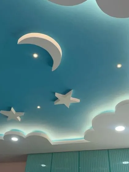 We love bringing imagination to life in kids' rooms. This dreamy false ceiling with clouds, a moon, and stars, complete with soft backlighting, creates a magical environment for any child.