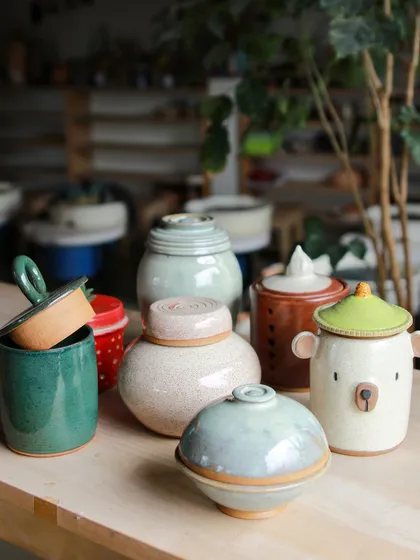A collection of lidded jars made by students, each with its own personality. From a cute bear-shaped jar to elegant, minimalist forms, their creativity is shining through.