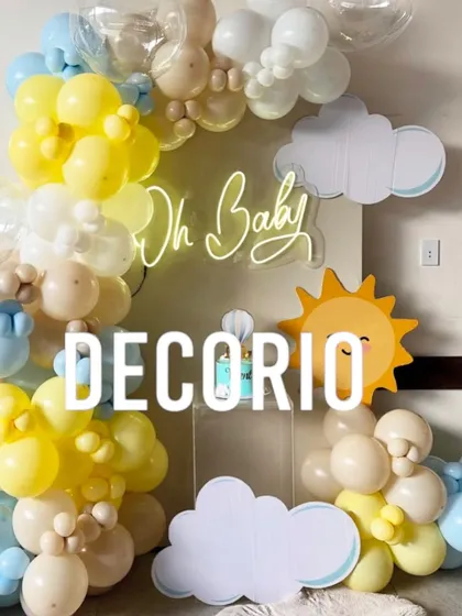 A cheerful and bright baby shower setup with a "You are my sunshine" feel. I used a yellow, blue, and white balloon arch, cloud and sun cutouts, and an "Oh Baby" neon sign to create this happy display.