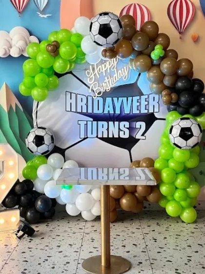 A goal-worthy football-themed birthday for Hridayveer's 2nd birthday, featuring a soccer ball backdrop and a green, black, and white balloon arch.