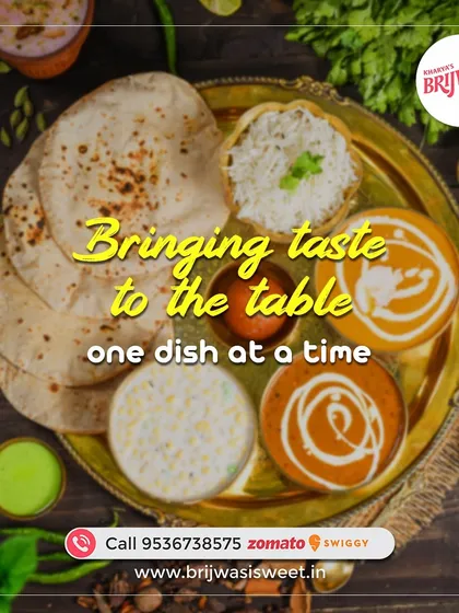 Bringing taste to the table, one dish at a time. This image shows a classic North Indian thali with two types of curries, raita, roti, rice, and gulab jamun.