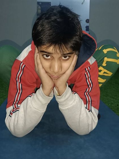 A young student in a variation of Malasana, or yogi squat. I always encourage kids to be playful and explore poses in their own way.