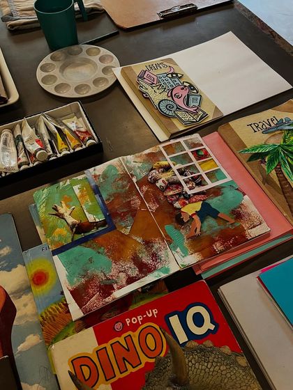 A collection of finished and in-progress artist books from our summer camp. You can see the variety of styles and themes, from travel journals to dinosaur pop-up books.