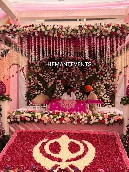 I design sacred spaces for religious ceremonies with the utmost care and detail. This is a beautiful Anand Karaj setup for a Sikh wedding, featuring a canopy decorated with hanging crystals, a backdrop of dense flowers, and a floral Sikh Khanda symbol.