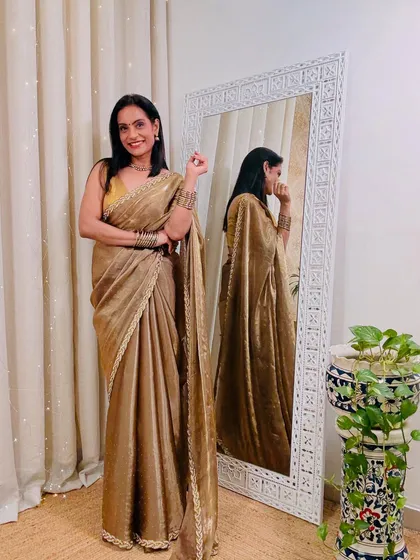 A glamorous golden tissue saree that is perfect for a wedding reception or a big party. This saree ensures you will be the center of attention.