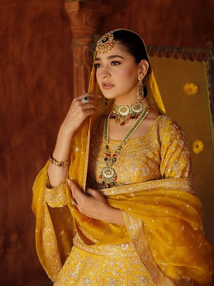 Another elegant portrait. The warm tones of the makeup and outfit are perfect for a daytime or golden-hour event.