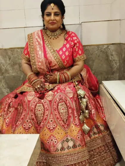 A lovely client dressed in a traditional pink and gold banarasi lehenga for a family wedding. The beautiful floral hairstyle complements the ethnic look perfectly.