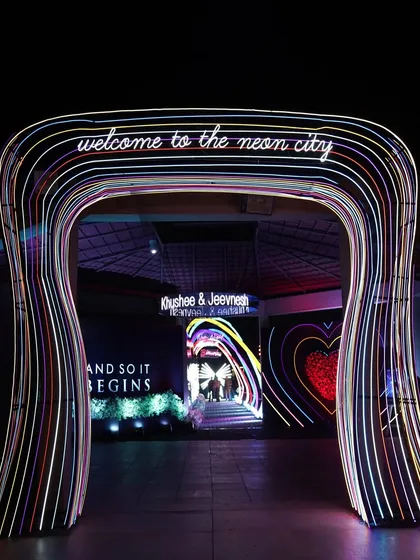We believe an event experience should start from the very first step. This custom-built neon archway served as a grand, immersive entrance for a Sangeet, immediately transporting guests into the vibrant 'Neon City' theme.