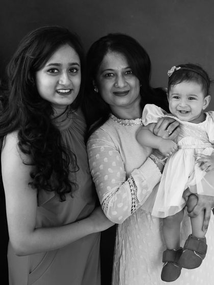 Three generations of love, captured in a timeless black and white portrait. This image celebrates the unbreakable bond between a grandmother, mother, and daughter.