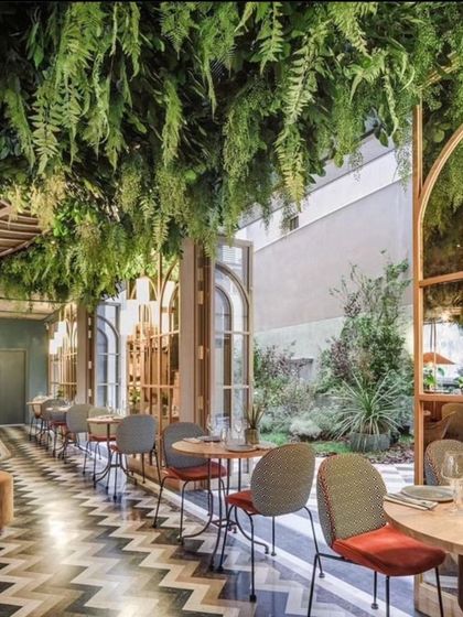 I also create dramatic ceiling installations. For this restaurant, I designed a suspended garden with hanging artificial ferns that covers the entire dining area, giving it a unique, immersive atmosphere.