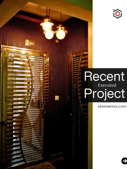 An elegant entrance with a dark wood door featuring a unique curved metal grill. The warm lighting creates a classic and inviting feel.