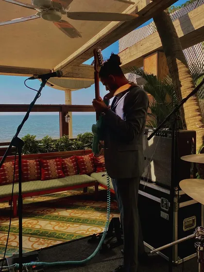 Our guitarist warming up during soundcheck at a beautiful seaside venue. Getting the sound just right is a critical part of our preparation for every show.