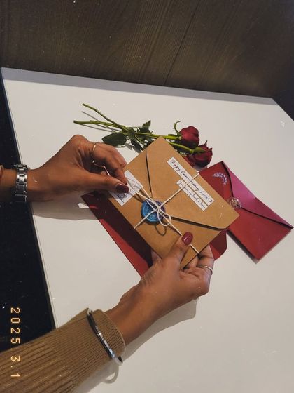 Sealing the anniversary envelope with a wax stamp. It’s a small touch that adds a lot of charm.