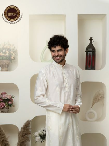 Elegance stitched to perfection. A smiling model in a classic white embroidered kurta, a picture of effortless charm.